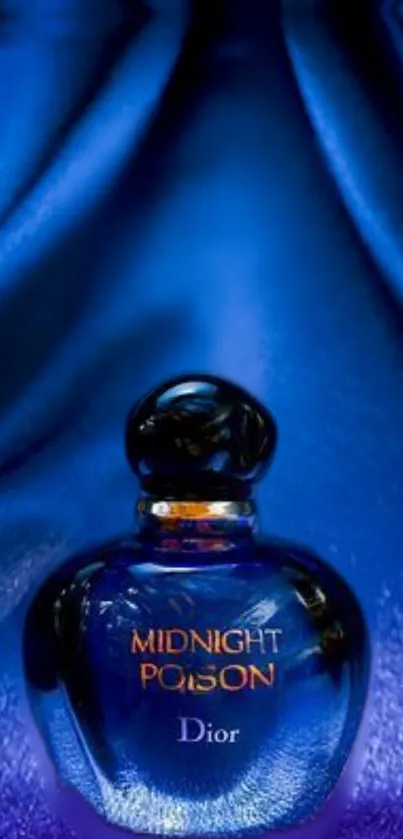 Midnight blue perfume bottle on satin fabric.