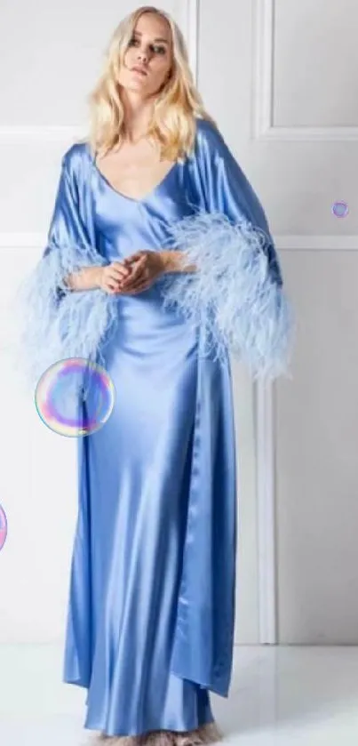 Model in elegant blue satin dress with feathered sleeves.