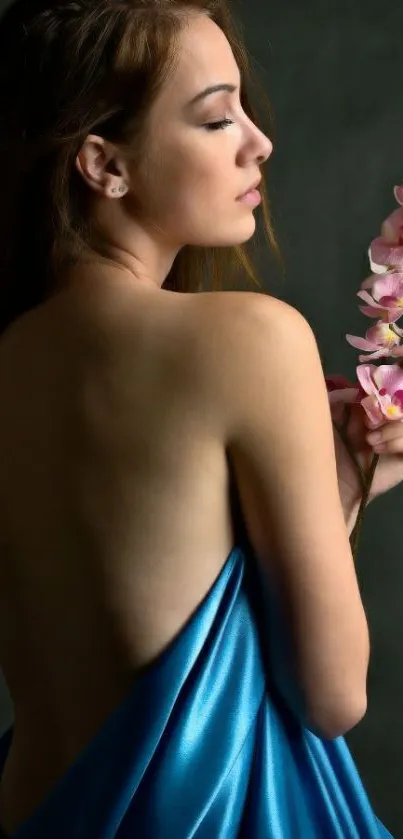 Woman draped in blue silk with pink orchids, elegant mobile wallpaper.