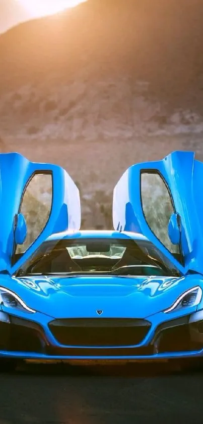 Blue sports car with scissor doors open against mountain backdrop.