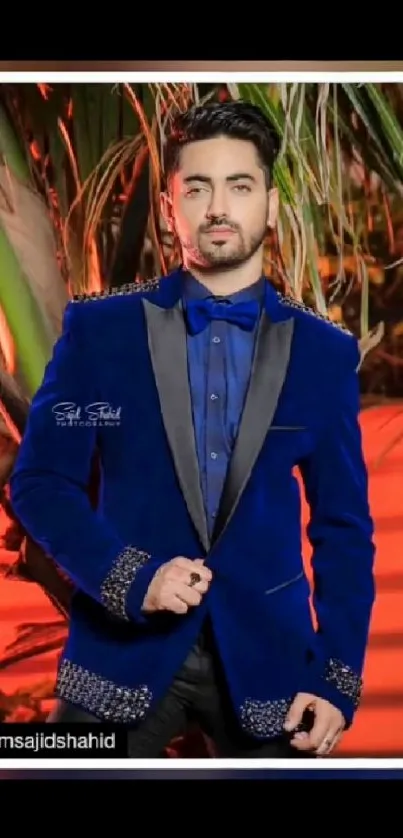 Man in stylish blue suit with tropical background.