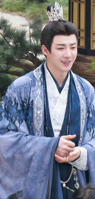 Man in elegant blue traditional attire with serene expression.