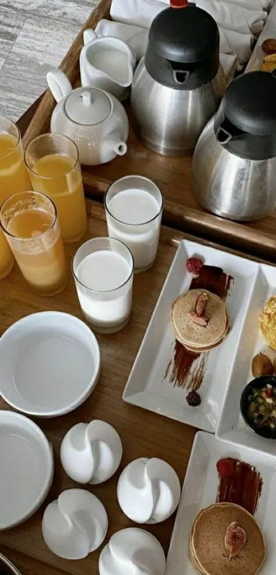 Elegant breakfast tray with pancakes and beverages.