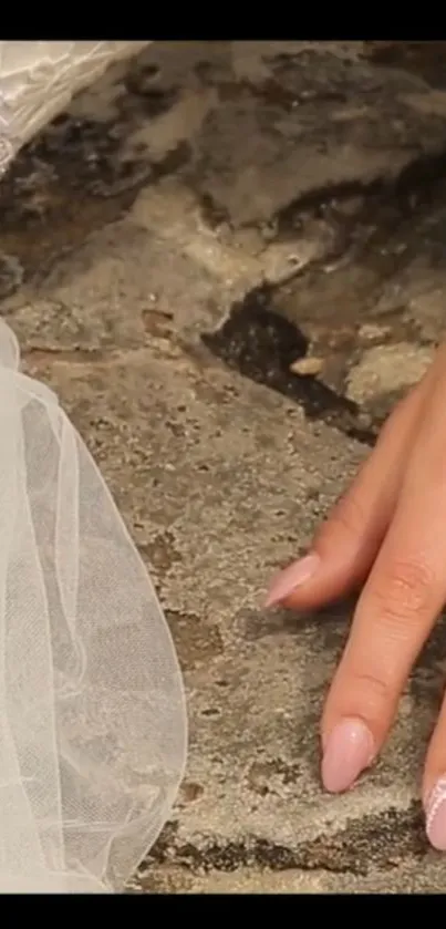 Bridal hand on textured stone background, elegant and classic wallpaper.