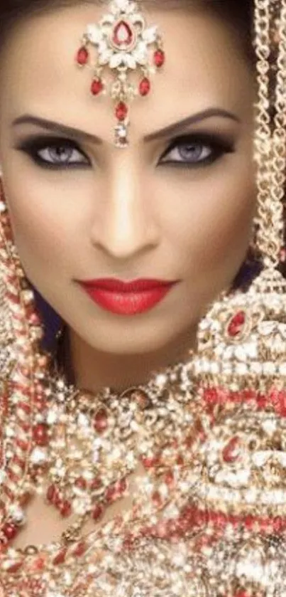 Elegant bridal portrait with red jewelry and intricate design.