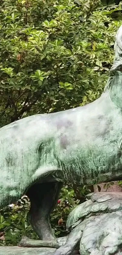 Bronze lion statue with lush green background.