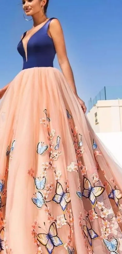 Elegant gown with butterfly design set against a blue sky background.