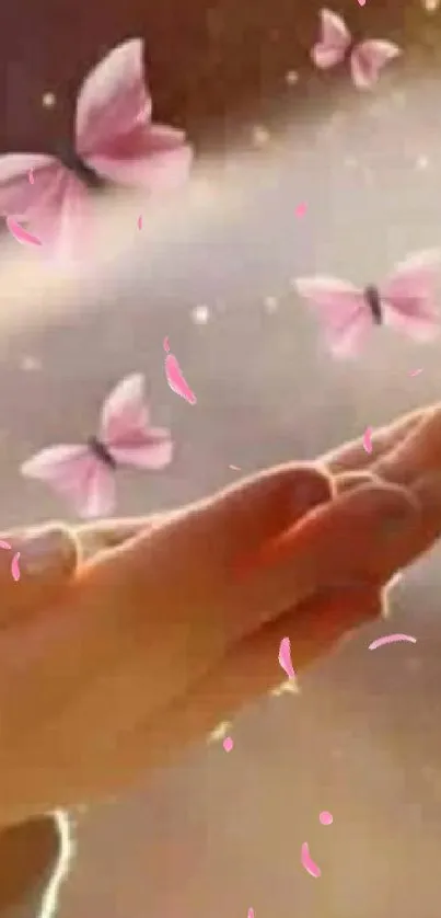 Hand with pink butterflies in glowing light.