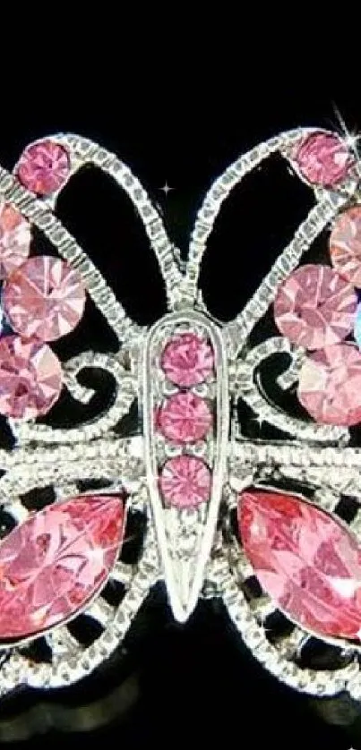 Elegant butterfly with pink jewel decorations on a black background.