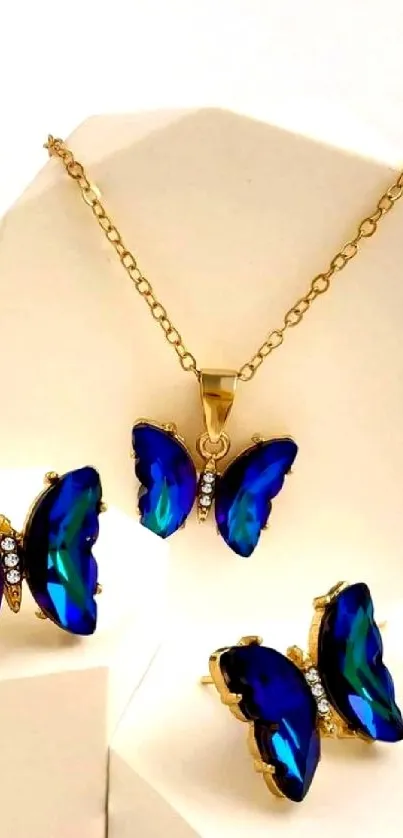Blue butterfly jewelry set on gold with elegant design.