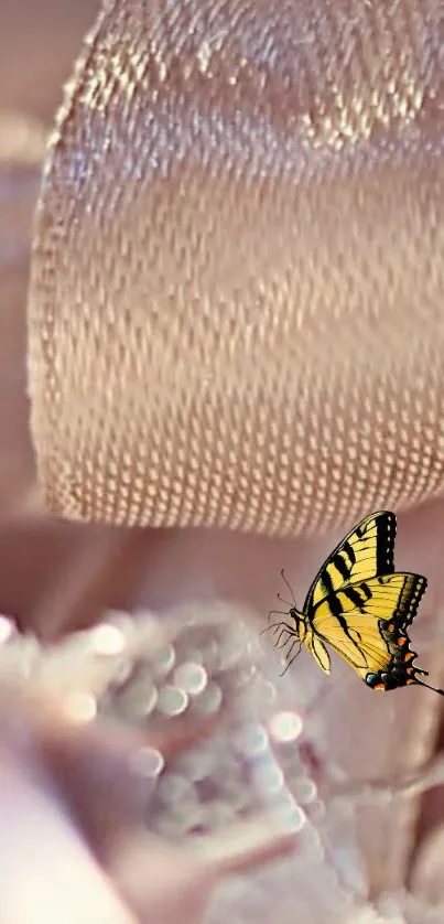 Delicate yellow butterfly rests on soft pink satin fabric.