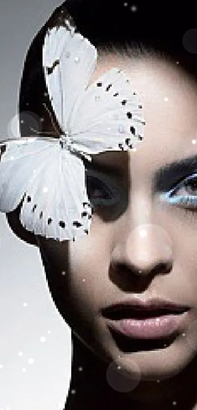 Portrait with delicate white butterfly and blue eyeshadow.