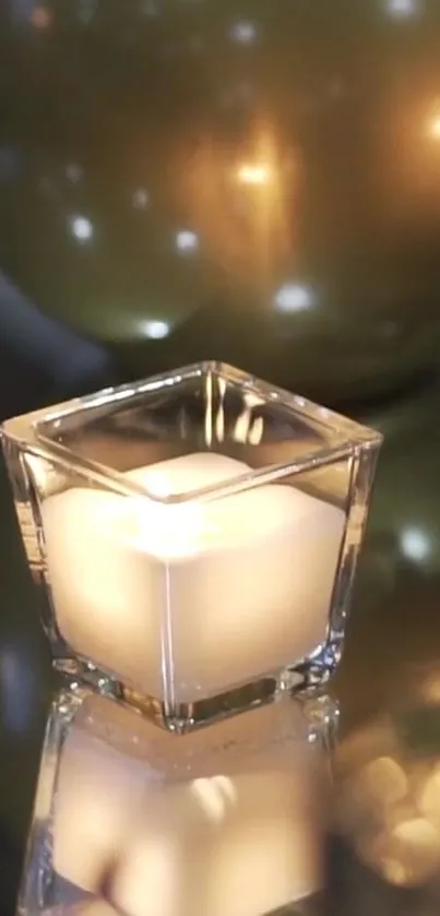 A candle with golden orbs creating a warm, elegant scene.