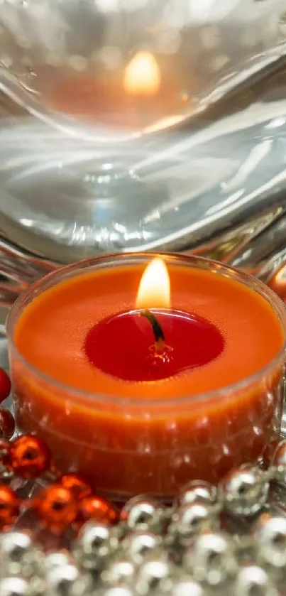 Candle with festive ornaments and glow.