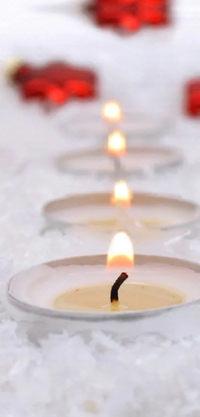 Elegant candles with a warm glow on a snowy background.