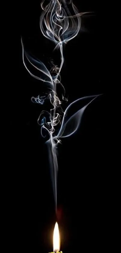 Candle with smoke forming flower shape on black background.