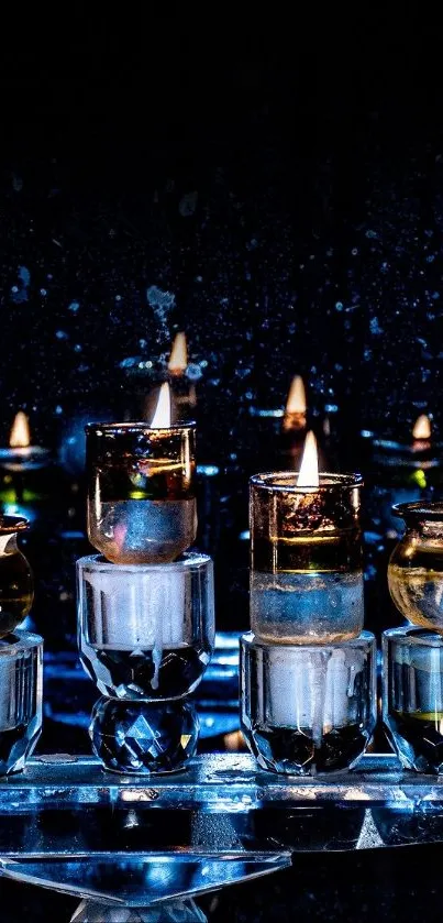 Candlelight arrangement with glowing flames in glass holders against a dark background.