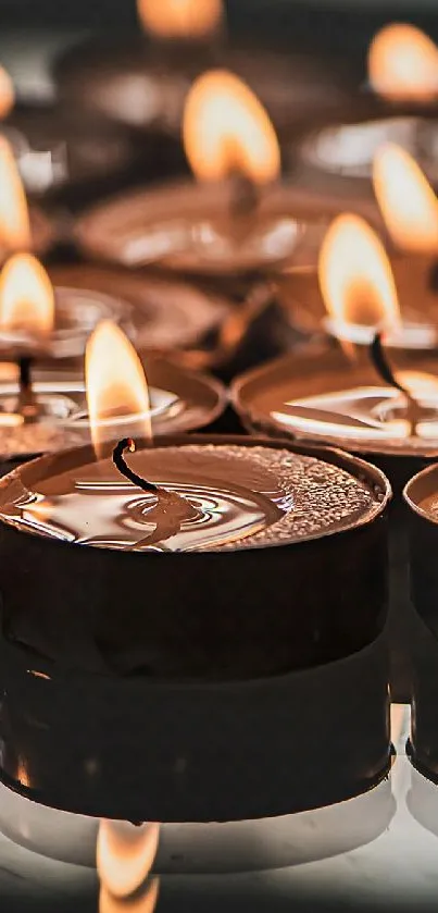 Multiple glowing candles creating a warm and tranquil atmosphere for phone display.