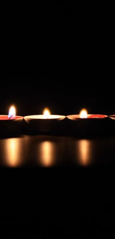 Five candles glowing softly in the dark, creating a serene ambiance.