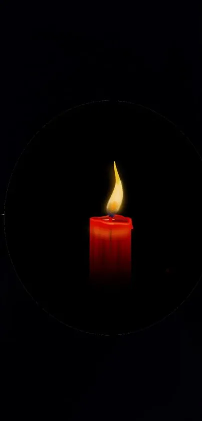 Red candle glowing softly against a dark background