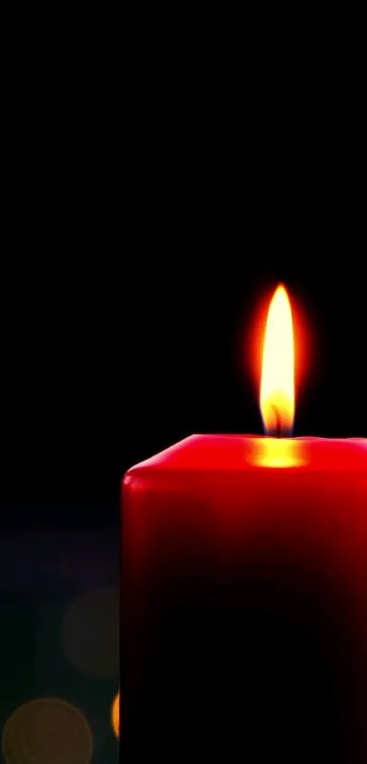 A bright red candle against a dark backdrop, emitting a warm glow.