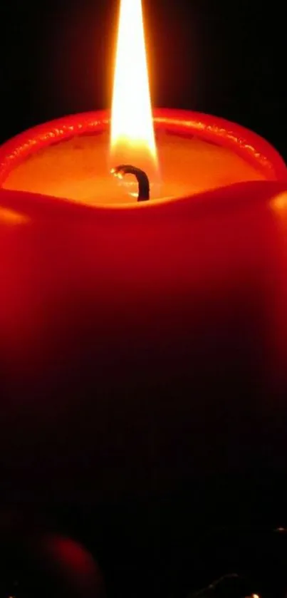 A glowing red candle in dark ambiance mobile wallpaper.