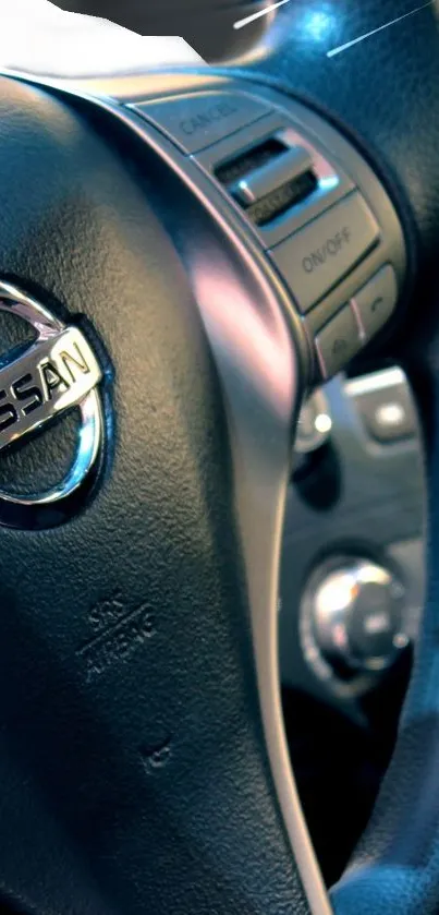 Close-up of a car steering wheel with metallic details and logo.