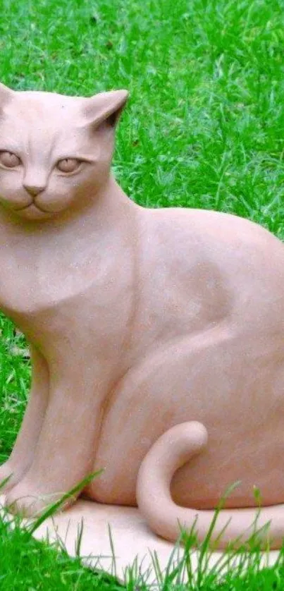 Clay cat sculpture on green grass wallpaper.