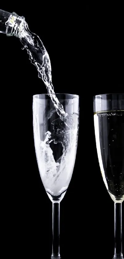 Pouring champagne into two crystal glasses on a black background.