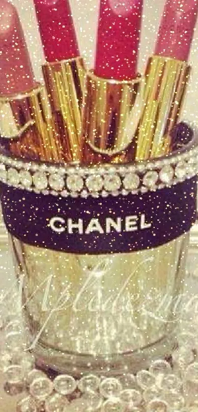 Chanel lipsticks in jeweled holder on elegant backdrop.