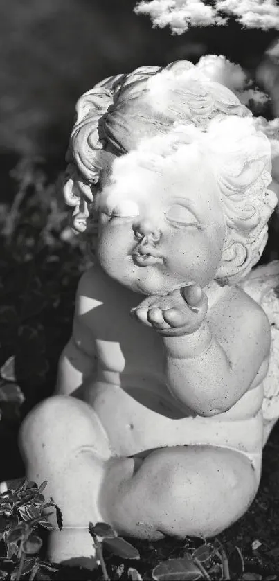 Grayscale cherub statue in a garden setting.