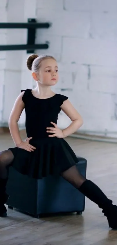 Child in ballet pose inside dance studio.