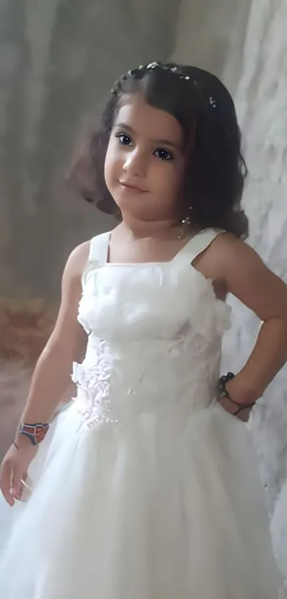 Child in elegant white dress, serene setting.