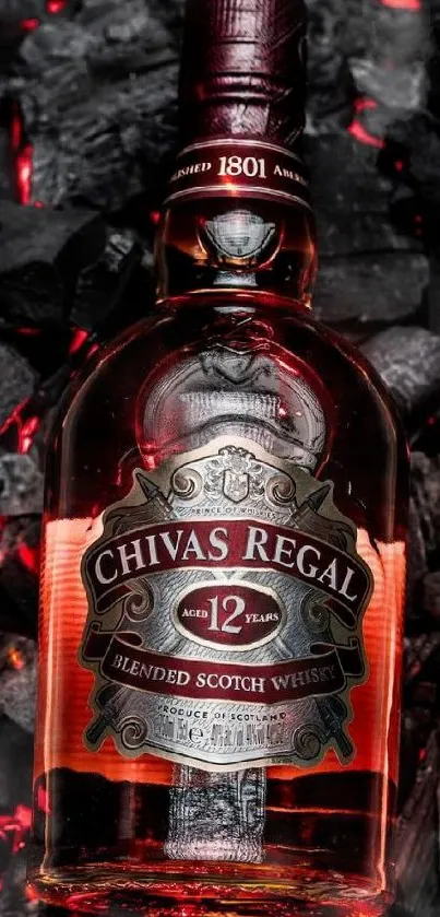 Chivas Regal bottle on burning charcoal background.