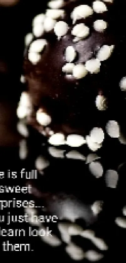 Minimalist black wallpaper with chocolate truffles.