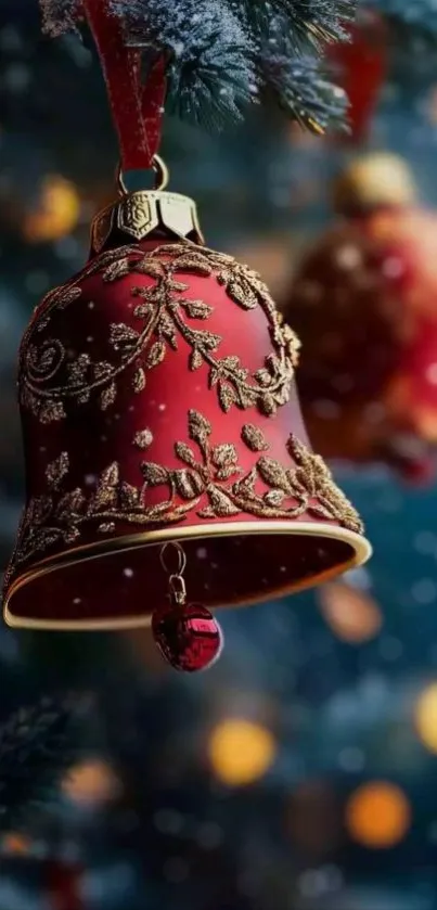 Red Christmas bell ornament with intricate designs on pine branches.