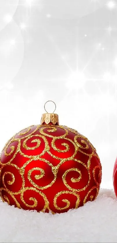 Elegant red Christmas ornaments in snow.