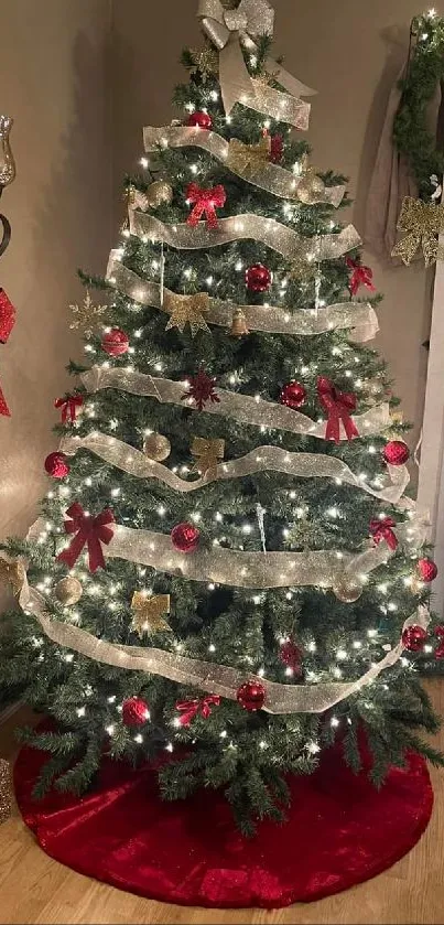 Elegantly decorated Christmas tree with lights and red bows in cozy room.