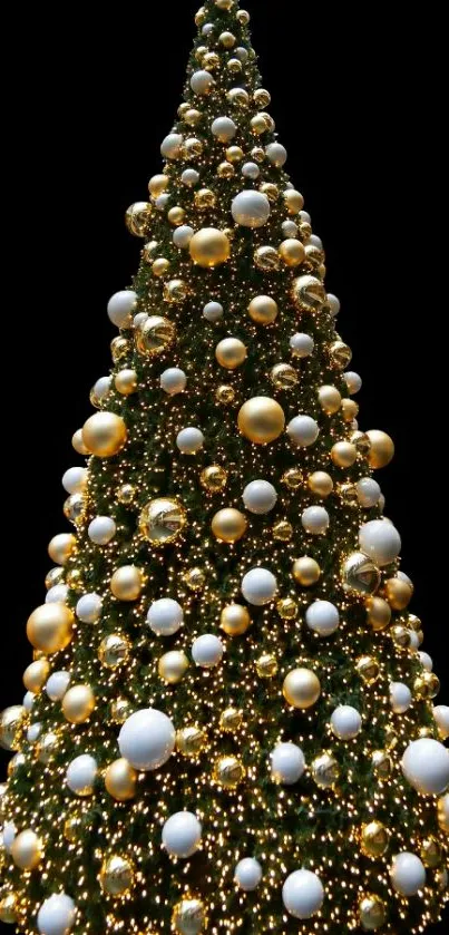 Elegant Christmas tree with gold and white ornaments on a black background.