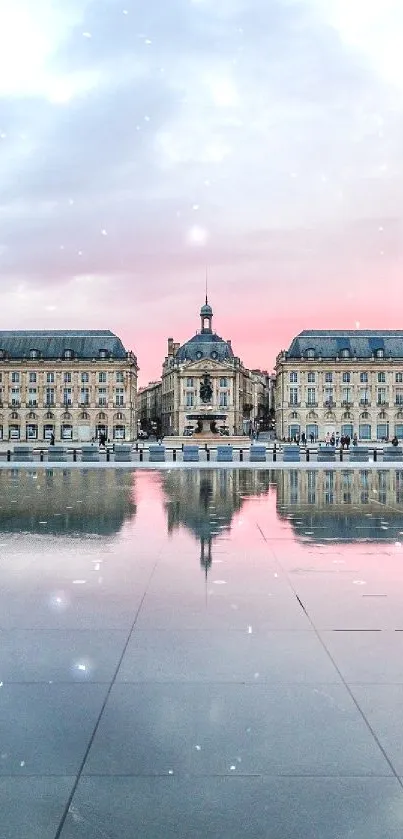 Elegant cityscape reflected in tranquil water with a pink and blue sunset.