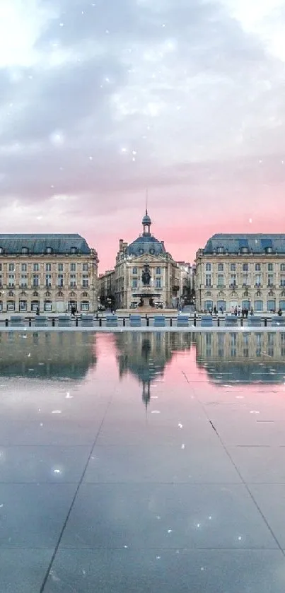 Classical architecture reflecting in calm water at sunset.