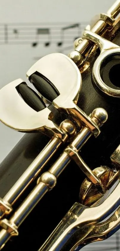 Close-up of a gold-accented clarinet with sheet music background.