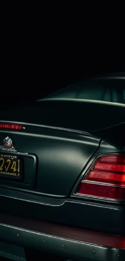 Classic car with red taillights under moody lighting.