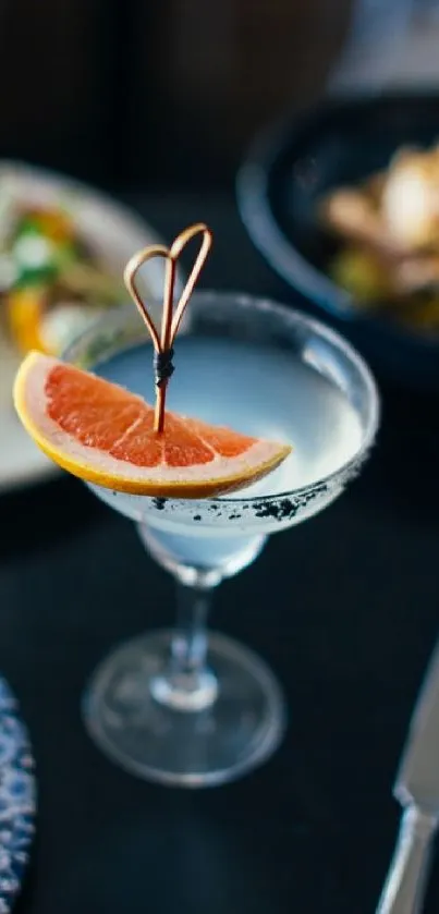 Elegant cocktail glass with grapefruit garnish on a stylish mobile wallpaper.