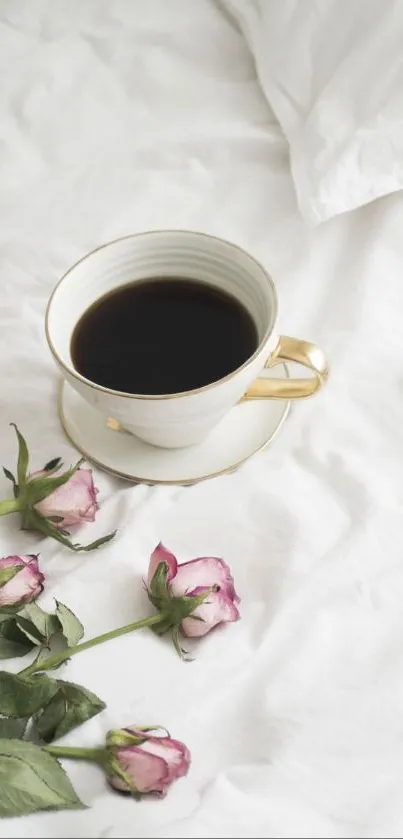 Elegant teacup of coffee with pink roses on a white bed.