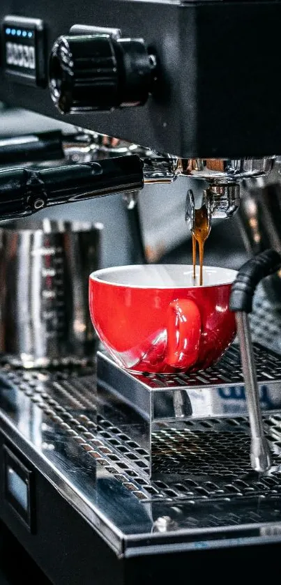 Red coffee cup on stainless steel espresso machine.