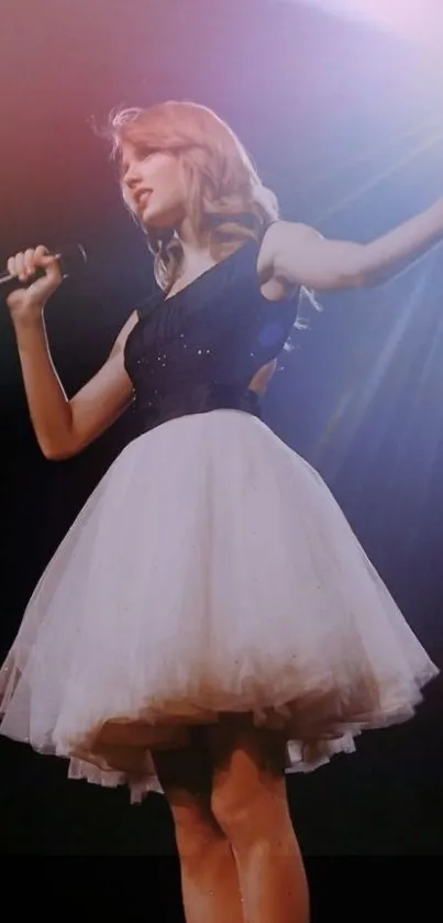 Performer in elegant dress on stage with microphone, soft lighting enhancing the moment.