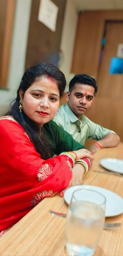 Couple in traditional attire dining at a restaurant.