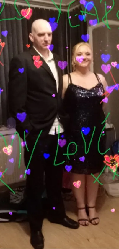 Couple celebrating anniversary with handwritten love note in elegant attire.