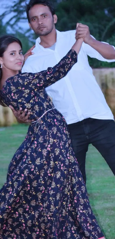 Elegant couple dancing in nature, displaying grace and movement in a serene setting.